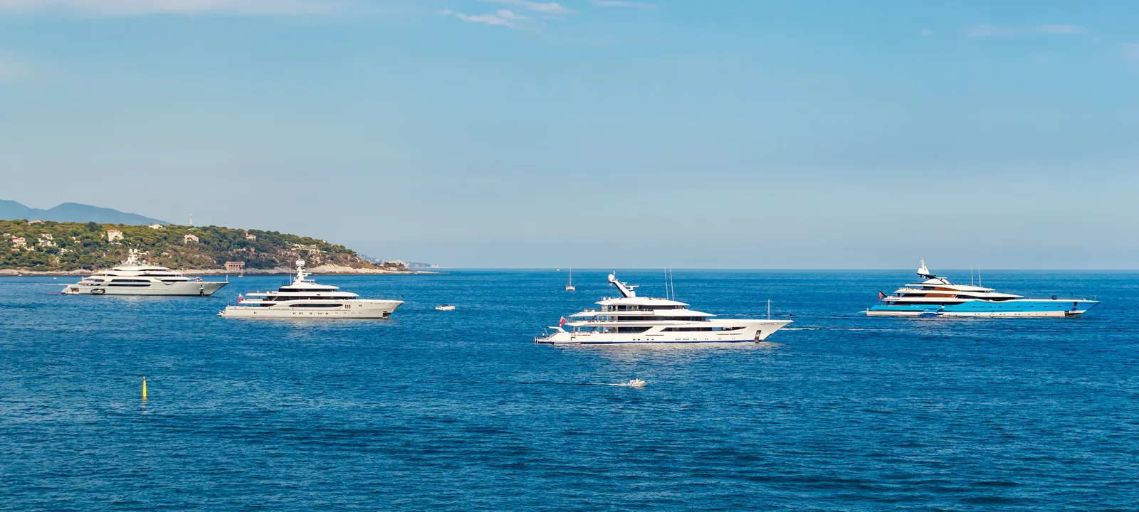 Why do superyachts fly Cayman Islands and Red Ensign flags?